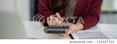 Real estate sales agent calculates property finance mortgage investment planning for home sales client transaction business success 132497339