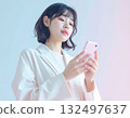 A young woman using chatGPT on her smartphone 132497637