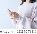 A young woman using chatGPT on her smartphone 132497638
