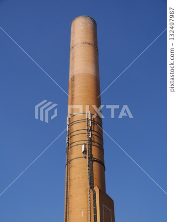 Tall brick tower with a blue sky in the background Tall brick tower with a blue sky in the background 132497987