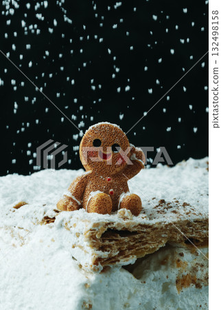gingerbread man resting under snowfall 132498158