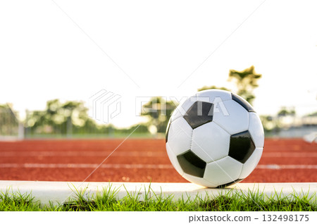 Footballs on the field and goal nets in a large stadium Footballs on the field and goal nets in a large stadium 132498175