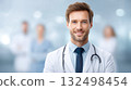 confident doctor with a stethoscope, smiling outside hospital with blurred healthcare team in background. 132498454