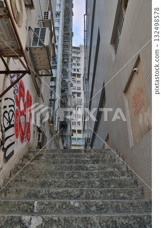 18 Oct 2025 Hidden alley with neon lights and urban textures 132498578