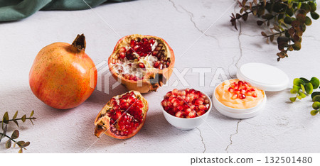 Pomegranate skin care cream in a jar and fruit on the table web banner Pomegranate skin care cream in a jar and fruit on the table web banner 132501480