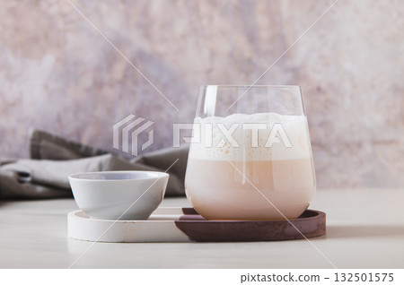 Cloudy pink matcha in a glass with airy foam on the table Cloudy pink matcha in a glass with airy foam on the table 132501575