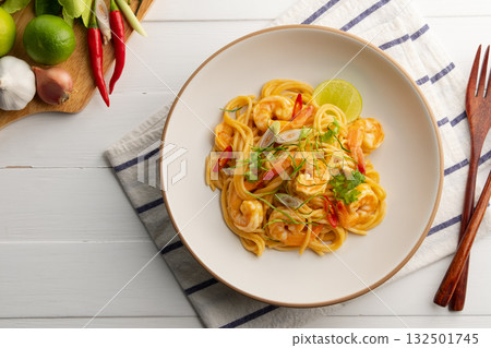 Creamy Spaghetti Tom Yum Kung,Thai style fusion food, spicy pasta with shrimp in tom yum sauce.Top view. Creamy Spaghetti Tom Yum Kung,Thai style fusion food, spicy pasta with shrimp in tom yum sauce.Top view. 132501745