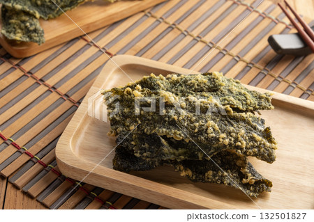 snack seaweed tempura chips,Deep fried Crispy Seaweed with flour, egg on a plate. snack seaweed tempura chips,Deep fried Crispy Seaweed with flour, egg on a plate. 132501827