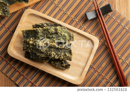 snack seaweed tempura chips,Deep fried Crispy Seaweed with flour, egg on a plate.Top view. 132501828