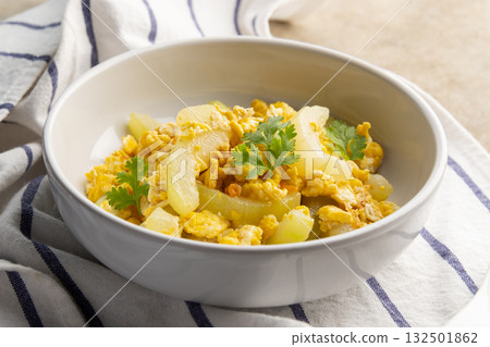 Stir Fried Winter Melon with Egg in white bowl. 132501862