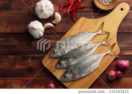 Raw fresh mackerel fish (short bodied mackerel ) on cutting board.Fresh seafood ingredients.Top view copy space. 132501872