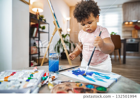 Child making bright art at home in the afternoon Child making bright art at home in the afternoon 132501994