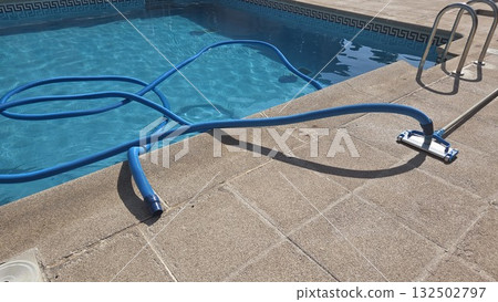 Pool cleaning equipment on a sunny day for maintenance and hygiene 132502797