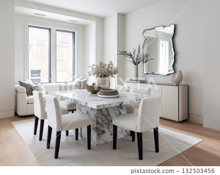 A chic, minimalist dining room featuring a round concrete table, white boucle chairs, an arched mirror, and dried floral arrangements against a neutral wall. A chic, minimalist dining room featuring a round concrete table, white boucle chairs, an arched mirror, and dried floral arrangements against a neutral wall. 132503456
