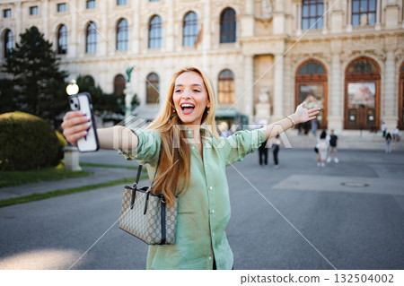 Happy young woman taking selfie in Vienna city 132504002