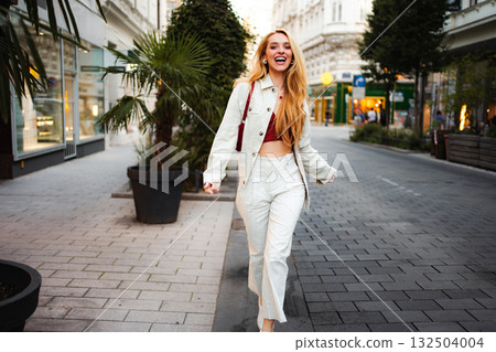 Happy young woman walking city street Vienna Austria 132504004