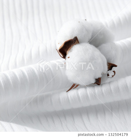 The soft, organic texture of cotton balls placed on white ribbed fabric The soft, organic texture of cotton balls placed on white ribbed fabric 132504179