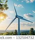Wind Turbine Close-Up on Blue Sky Background with Glowing Sunlight 132504732