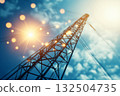 High-voltage transmission tower against blue sky with sunlight 132504735