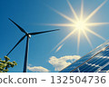 Solar panel and wind turbine under bright sky with white summer clouds 132504736