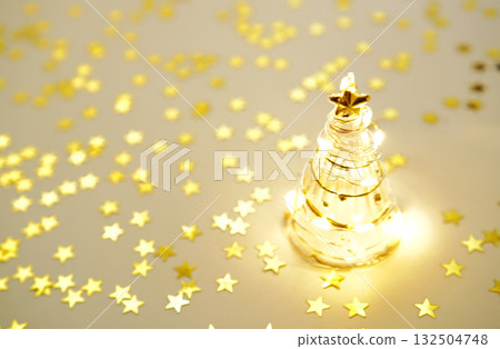 Glass Christmas tree and sparkling gold star Glass Christmas tree and sparkling gold star 132504748