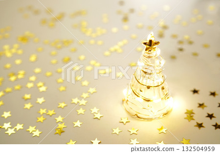 Glass Christmas tree and sparkling gold star 132504959