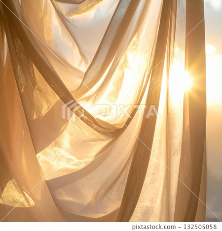 A thin curtain fabric with beautiful drapes that lets light through in the setting sun. 132505058