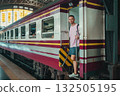 traveler guy boarding train at busy railroad station, young man with backpack starting journey on railway platform 132505195