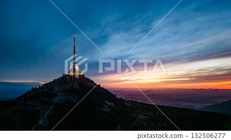 The Jested Mountain Hotel stands tall and illuminated against a beautiful dusk sky in Liberec, Czechia. The modern structure captures evening light as night approaches. The Jested Mountain Hotel stands tall and illuminated against a beautiful dusk sky in Liberec, Czechia. The modern structure captures evening light as night approaches. 132506277
