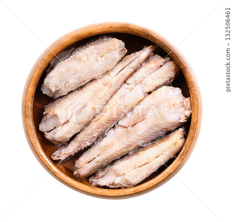 Sardine fillets, skinless and boneless canned sardines in vegetable oil, in a wooden bowl. Wild-caught sardines, also called pilchards, a small, oily fish, and rich source of omega-3 fatty acids. Sardine fillets, skinless and boneless canned sardines in vegetable oil, in a wooden bowl. Wild-caught sardines, also called pilchards, a small, oily fish, and rich source of omega-3 fatty acids. 132506461