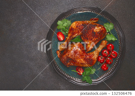 grilled fried chicken legs, served with fresh cherry tomatoes and herbs, on a plate, homemade, no people, 132506476
