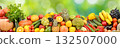 Photo of bright healthy fruits, vegetables and berries on a green natural background. 132507000