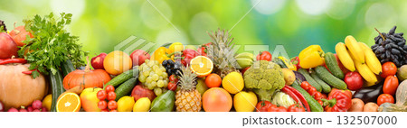 Photo of bright healthy fruits, vegetables and berries on a green natural background. Photo of bright healthy fruits, vegetables and berries on a green natural background. 132507000