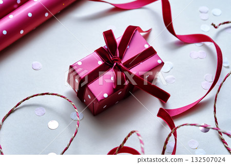 A light Christmas background with a red polka dot gift. 132507024