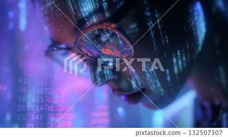 Programmer engaged with holographic code in a futuristic workspace late at night 132507307