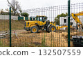 Orange bulldozer at a construction site on a cloudy day. Construction equipment moves sand 132507559