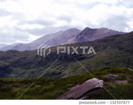 Breathtaking panorama. Emerald hills stretch towards distant peaks. Nature's beauty unveiled. Breathtaking panorama. Emerald hills stretch towards distant peaks. Nature's beauty unveiled. 132507877