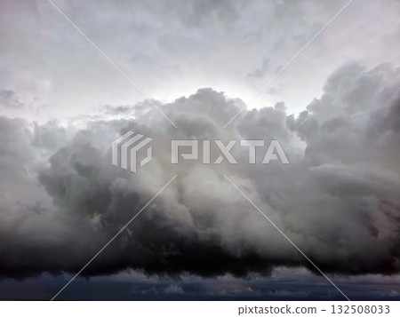 Low, thick thunderclouds loom in the sky, signaling the arrival of Hurricane Storm Dana. The atmosphere is tense and foreboding as the storm prepares to unleash its power. 132508033