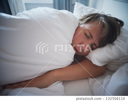 Lonely 35 year old woman sleeping alone after breakup, sadness and emotional emptiness  132508110