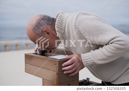 Elderly man drinking from a public fountain in Portugal. accessible water Elderly man drinking from a public fountain in Portugal. accessible water 132508205