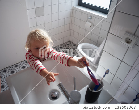 Little 4-year-old girl learning to brush her teeth by herself at home Little 4-year-old girl learning to brush her teeth by herself at home 132508308