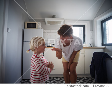 Little girl begging for cookies in the kitchen while her mother gently says no to more sweets Little girl begging for cookies in the kitchen while her mother gently says no to more sweets 132508309