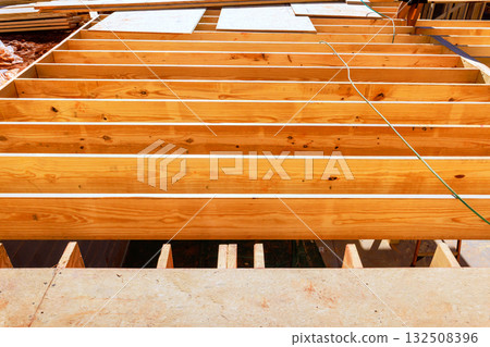 Workers are preparing wooden beams for new construction project Workers are preparing wooden beams for new construction project 132508396