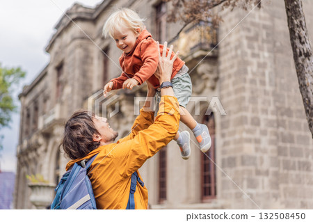 Father playfully tossing his young son in the air in front of Chapultepec Castle in Mexico City. Family travel, cultural heritage, joy, and bonding moment Father playfully tossing his young son in the air in front of Chapultepec Castle in Mexico City. Family travel, cultural heritage, joy, and bonding moment 132508450