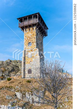 The lookout tower stands tall on Wysoki Kamien, offering stunning views of the Jizera Mountains. It is surrounded by rocky terrain and a tranquil landscape, ideal for hiking and relaxation. The lookout tower stands tall on Wysoki Kamien, offering stunning views of the Jizera Mountains. It is surrounded by rocky terrain and a tranquil landscape, ideal for hiking and relaxation. 132508662