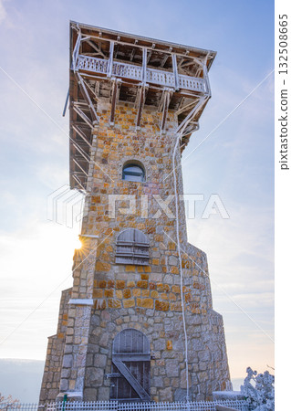 The lookout tower on Wysoki Kamien offers stunning views of the Jizera Mountains. Visitors can enjoy the scenic landscape and fresh air, making it a perfect spot for nature lovers. The lookout tower on Wysoki Kamien offers stunning views of the Jizera Mountains. Visitors can enjoy the scenic landscape and fresh air, making it a perfect spot for nature lovers. 132508665