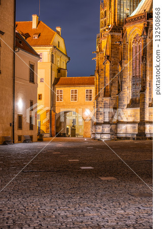At night, the cobblestone path leading to the covered bridge at Saint Vitus Cathedral illuminates, highlighting the architectural beauty of Prague Castle and its serene atmosphere. At night, the cobblestone path leading to the covered bridge at Saint Vitus Cathedral illuminates, highlighting the architectural beauty of Prague Castle and its serene atmosphere. 132508668