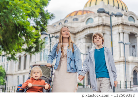 Mother tourist with her two sons in front of Palacio de Bellas Artes in Mexico City, enjoying family travel, architecture, and cultural heritage. Family travel and bonding concept 132509388