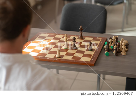 Middle aged Caucasian man playing chess. Middle aged Caucasian man playing chess. 132509407