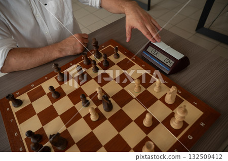 A man switches a chess clock.  132509412